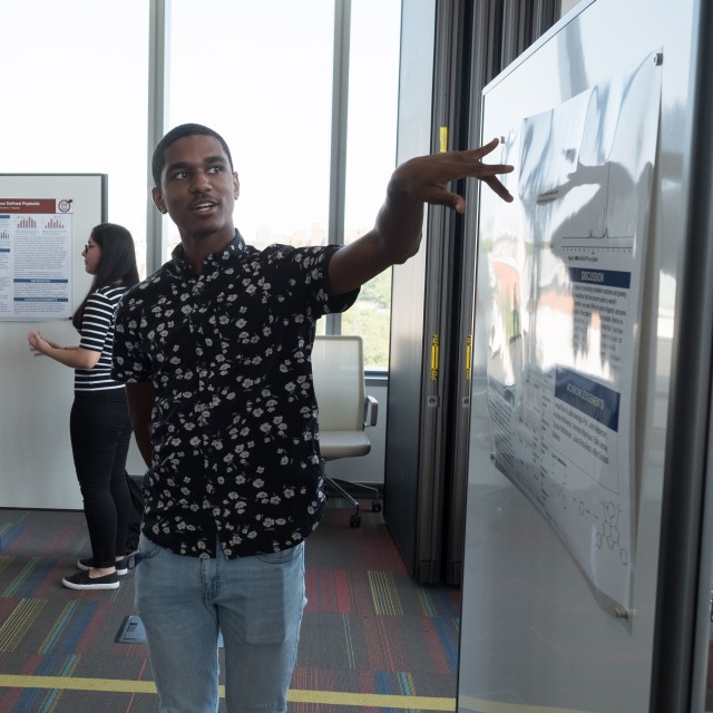 Undergraduate REU student presents his data at a poster session